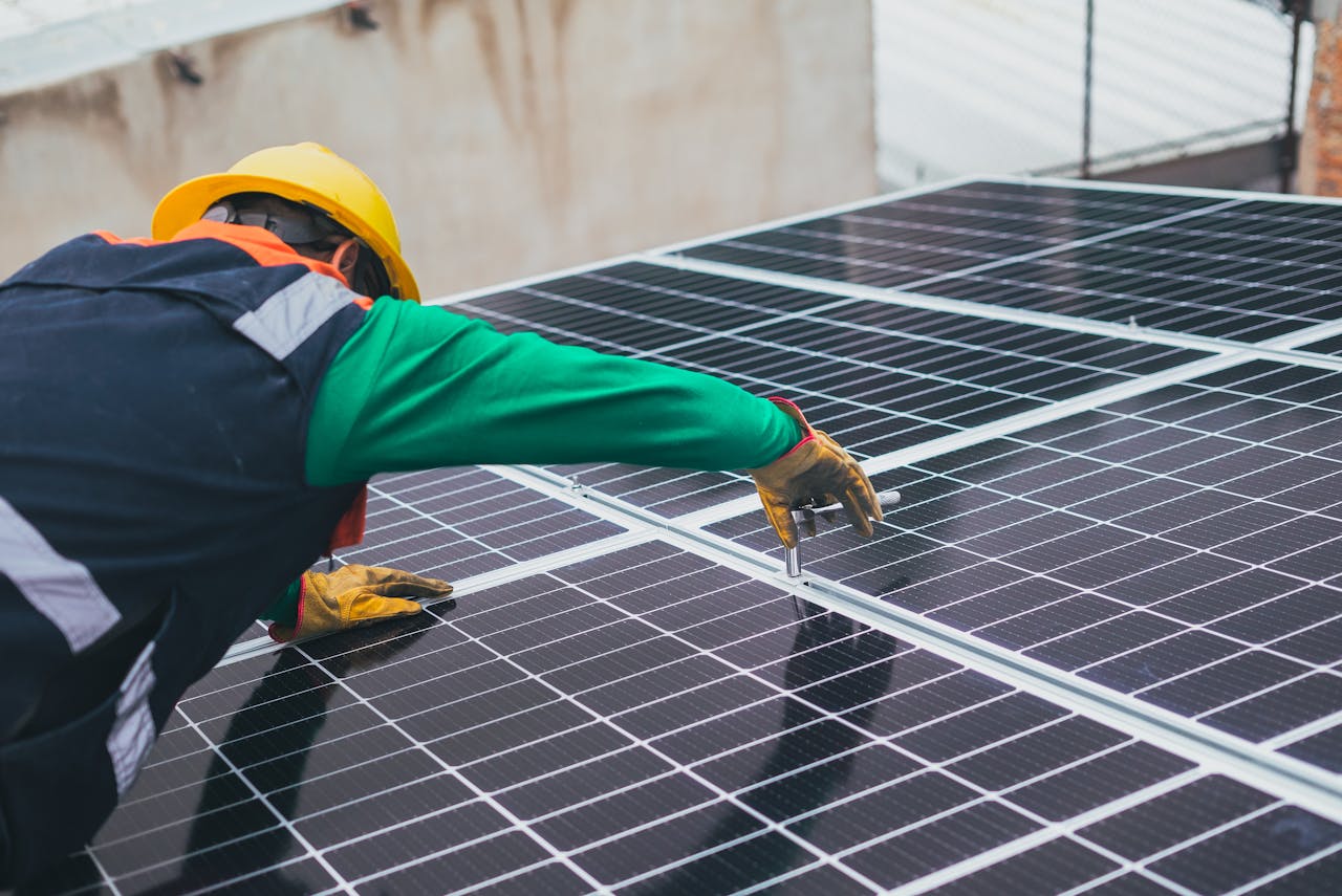 services-01 Technician installing solar panels on a rooftop for sustainable energy solutions.