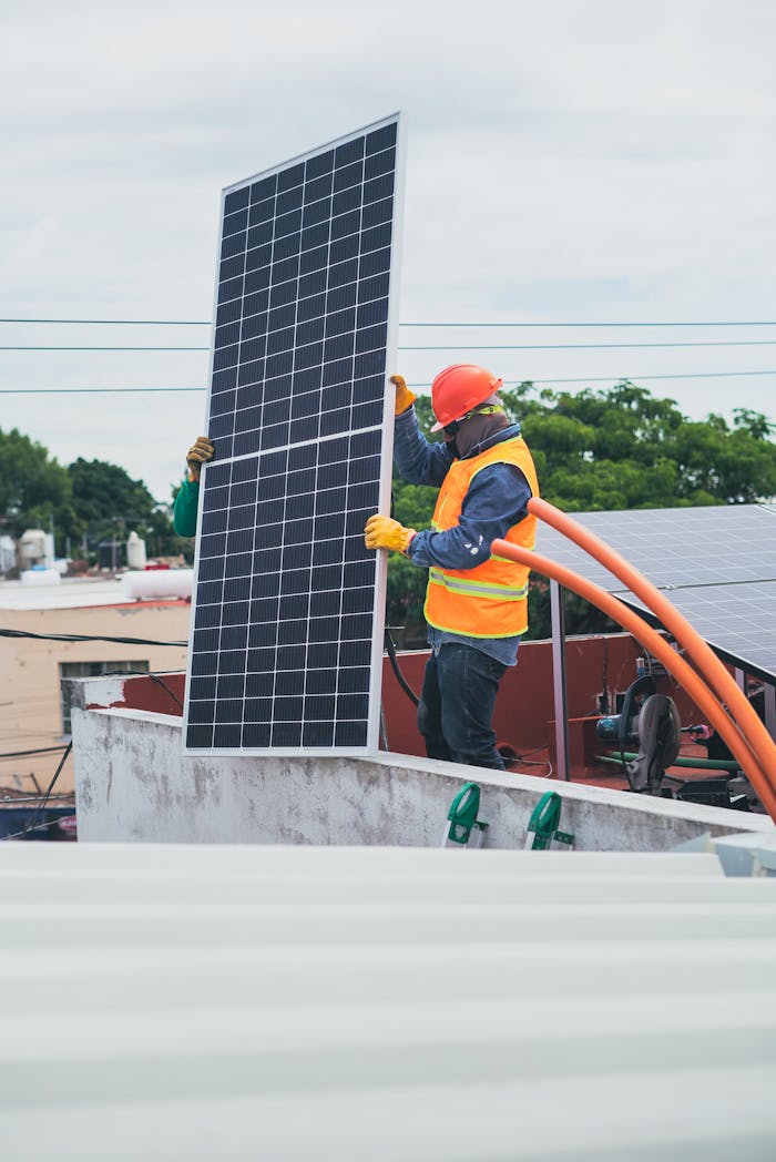 services-02 A technician in safety gear installs a solar panel on a rooftop, promoting renewable energy.